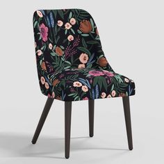 an upholstered chair with floral print on the back and wooden legs, against a white background