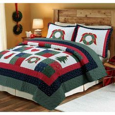 a bed with a christmas themed comforter and pillows