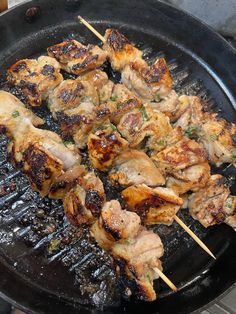 chicken skewers are being cooked on a grill