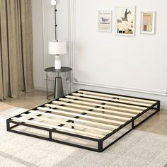 a bed frame sitting on top of a white rug