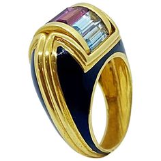 This magnificent 18 karat yellow gold ring is designed by the world renowned Italian company La Nouvelle Bague. They are known for their exquisite enamel work, and their unique signature style marrying the classic with the modern. The dome shaped ring is set with black enamel and yellow gold details. The center of the ring is set with semi precious baguette stones of amethyst, pink tourmaline and light blue topaz. The company's logo LNB is stamped on the side. Ring size 8 Luxury 14k Yellow Gold Enamel Ring, Luxury Ceremonial Yellow Gold Enamel Ring, Luxury Collectible Yellow Gold Enamel Ring, Luxury Yellow Gold Enamel Ring With Cabochon, Luxury Elegant Multi-stone Enamel Ring, Bagan, Domed Ring, Gold Details, Black Enamel