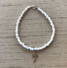 Super pretty white anklet! The anklet comes with one charm....pick your fave from the many we have available! Next, pick your size and we will get you fixed up with a gorgeous piece of jewelry you will be proud to wear! Our anklets are made to last using premium beading wire and beads. We have many colors to choose from so please check out our other listings as well! If you're not absolutely sure of the size you need, I am more than happy to add an extension that will give you some wiggle room.. Handmade White Anklet Bracelet, Adjustable White Anklets With Tiny Beads, White Beaded Anklets With Round Beads, Adjustable White Beaded Anklets, Seed Bead Anklet, Flamingo Jewelry, Bead Anklet, Charm Anklet, Summer Anklets