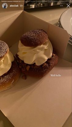 two pastries sitting in a box on top of a table