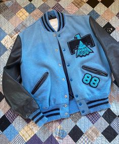 SUPER RARE baby blue wool & leather Thunderbird varsity letterman jacket. Marked size 42, fits like mens large, check measurements below. Overall good condition with a lightly faded spot where a previous patch was. MEASUREMENTS: Chest: 23" across Length: 25" Sleeve: 25" Shoulders: 19" across Blue College Varsity Jacket With Button Closure, Blue Varsity Jacket With Button Closure For College, College Blue Varsity Jacket With Button Closure, Blue Varsity Jacket With Patchwork, Blue Varsity Jacket With Button Closure For Streetwear, Blue Patchwork Varsity Jacket, Blue Varsity Jacket For Streetwear, Collegiate Blue Varsity Jacket For Fall, Blue Outerwear With Baseball Collar For School