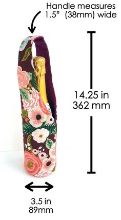 the measurements for a wine bottle holder with flowers on it and an arrow pointing up