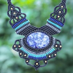 Create a statement with this standout bohemian necklace designed by Thailand's Kanjana. The artisan hand knots blue black and grey polyester cords around a large mottled sodalite stone using macrame techniques while petite brass beads adding shining accents. A sliding knot closure lets you adjust the necklace to the length of your liking. Bohemian Jewels, Bead Pendant Necklace, Funky Earrings, Wristband Bracelet, Bead Pendant, Beaded Pendant Necklace, Sliding Knot, Macrame Necklace, Bohemian Necklace