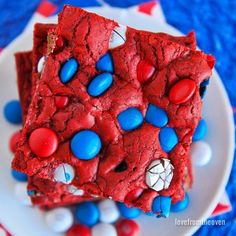 red, white and blue dessert squares on a plate with m & m candies