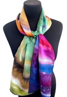 a multicolored tie dyed scarf on a mannequin