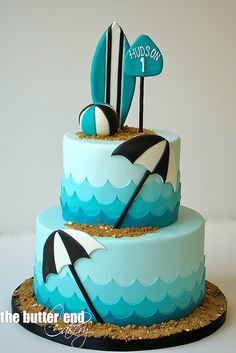 a blue and white cake with an umbrella on top