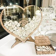 a heart shaped display on top of a table next to some wine glasses and silverware