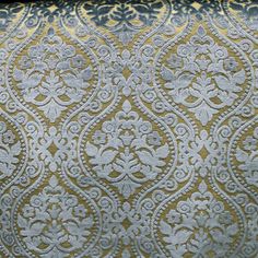 an ornate gold and blue pattern on fabric