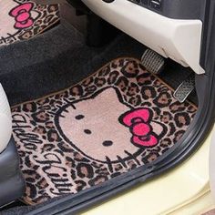 a hello kitty car mat in the trunk of a car