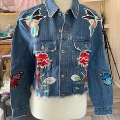 Embroidered & Appliqud Frayed Bottom & Raw Edges In This Adorable Denim Jacket. 2 Breast Pockets & 2 Faux Side Pockets. 100% Cotton Trendy Denim Jacket With Embroidered Patch For Spring, Trendy Medium Wash Outerwear With Floral Embroidery, Trendy Denim Jacket With Floral Embroidery For Fall, Blue Denim Jacket With Embroidered Patch For Spring, Blue Denim Jacket With Embroidered Patch For Fall, Trendy Floral Embroidery Denim Jacket For Fall, Fitted Denim Jacket With Patches For Spring, Spring Blue Outerwear With Patches, Spring Denim Outerwear With Patches