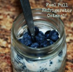 a glass jar filled with blueberries and yogurt