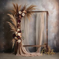 an old photo frame with flowers and feathers on the top is displayed in front of a backdrop