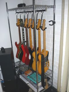 there is a rack with guitars on it