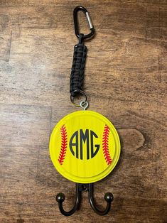 a key chain with a baseball on it and an amg hook attached to it