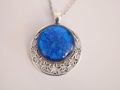 This beautiful silver metal star pendant with dichroic blue glass center is definitely and eye catcher! The dichroic glass is a special type of glass which can show different colors depending on the angle it is viewed at. The blue color looks like a glistening night sky. The Silver tone pendant is accentuated with cut out stars giving this necklace a truly celestial feel to it Pendant is 2 inches long Chain is 20 inches and is steel If you love celestial or Victorian jewelry or just looking for Celestial Necklace, Metal Stars, Key To My Heart, Steel Metal, Dichroic Glass, Victorian Jewelry, Star Pendant, Metal Chain, Cute Earrings