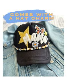 a black hat with gold stars on it and the words, comes with a hat charm