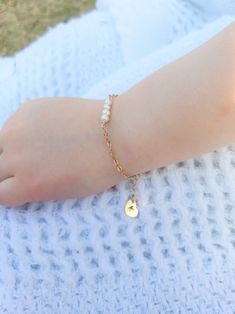 "Pearl and Gold Baby Bracelet/ 14 K Gold Filled Toddler Bracelet/ Little Girl Bracelet with Initial/ Baby Bracelet with Heart Charm Precious little bracelet is perfect for newborn gift, baptism/christening gift, 1st birthday gift, or just to show you care gift!! Stunning as flower girl bracelet too!! Really any occasion! Four delicate, 4 mm fresh water pearls adorn this golf filled bracelet. Gold Filled Chain is 2x2.3 mm, making this a sturdy chain that resists breaking from yanks or tugs of lit Adjustable Pearl Charm Bracelet For Birthday, Adjustable Gold Bracelet With Pearl Charm As Gift, Toddler Bracelet, Flower Girl Bracelets, Girl Bracelet, Bracelet With Heart, Bracelet Pearl, 1st Birthday Gifts, Baby Bracelet