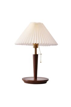 a table lamp with a wooden base and white shade on the top, sitting on a wood stand