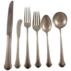 an assortment of silverware including forks, knives and spoons on a white background