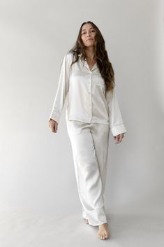 Our Silk Pajama Pant is here. Made from 100% mulberry silk fabric treated with aloe vera for a soothing touch. Perfect for lounging and sleeping, this lightweight, ultra-luxe sleep pant is designed for comfort with a relaxed wide-leg fit and adjustable elastic waistband. Luxury details include mulberry silk piping, inner French seams, and an eco-friendly plated logo charm. Pair it with our silk short-sleeve or long-sleeve pajama top for the ultimate silk sleep set. Women's Serenity Silk Classic Classy Loungewear, Silk Pajama Pants, Nightwear Dress, Luxury Details, Mulberry Silk Fabric, White Pajamas, Classic Pajamas, Silk Pajama, Bamboo Pajamas