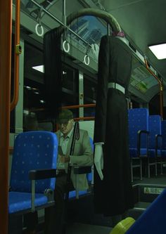 mannequins dressed in black and white are on the train with blue seats