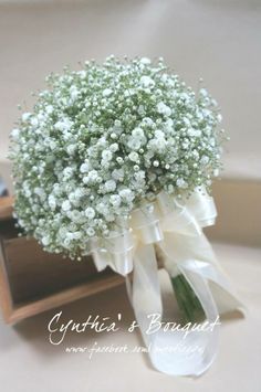 a bouquet of baby's breath in a wooden box