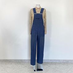 Vintage 70s blue denim jumpsuit. The jumpsuit has three pockets. Fabric: denim/jeans Size: There are no size labels, but I think it's about right for a size S. You see it on a size S mannequin, but I recommend checking the exact measurements MEASURES Waist: 39cm / 15.3" (flat) Hip: 48cm / 18.8" (at waist) Length: 150cm / 59" Leg Length: 72cm/28.3" The jumpsuit is in excellent condition Follow me on  INSTAGRAM: TOOMUCHMARION PINTEREST: TOOMUCHMARION 70s Denim Jumpsuit, Vintage Blue Denim Overall Jumpsuit, Vintage Cotton Denim Jumpsuit With Button Closure, Full-length Blue Denim Jumpsuit, 1970s Jumpsuit, Mid-rise Denim Blue Cotton Jumpsuit, Blue Full-length Cotton Denim Jumpsuit, Jumpsuit Denim, Overalls Vintage