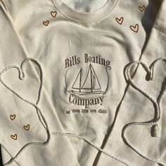 two white shirts with hearts on them and the words bills boating company printed on them