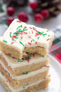 three pieces of cake with white frosting and sprinkles on a plate