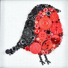 a red and black bird made out of buttons