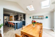 an open kitchen and dining room with skylights