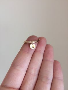 "Gorgeous luxurious minimalistic boho twisted and slim ring initial duo! Great subtle accent made personalized just for you. Wonderful 14k yellow gold filled twist band and simply slim smooth band are bound by a tiny dot/ disc charm that you may personalize with either 2 letters, 2 numbers, leave blank, or you may add a heart. Disc is a tiny 6mm! So beautiful and stacks great with other stacking rings! Pictured is bright polished 14k Yellow Gold fill. Materials: 16 gauge twisted wire 16 gauge ro Dainty Stackable Initial Open Ring, Dainty Stackable Initial Ring With Open Design, Dainty Initial Open Ring Stackable, Dainty Adjustable Stackable Initials Rings, Dainty Adjustable Stackable Rings With Initials, Dainty Initial Ring For Promise Occasions, Dainty Sterling Silver Stackable Rings With Initials, Dainty Tiny Initial Ring, Dainty Adjustable Hypoallergenic Initial Ring