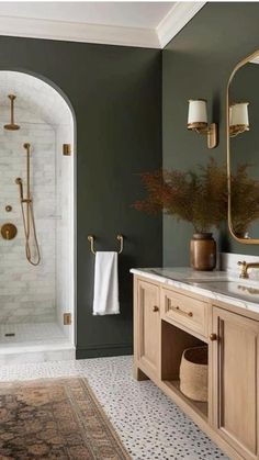 a bathroom with green walls and gold fixtures