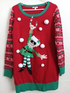 an ugly christmas sweater hanging on a wall