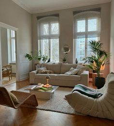 a living room filled with furniture and lots of windows