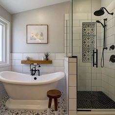 a white bath tub sitting next to a walk in shower