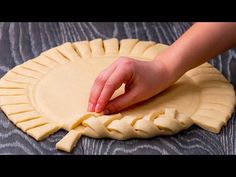 a person is making a pie crust on a table