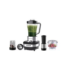 a blender filled with green liquid next to other items on a white background,