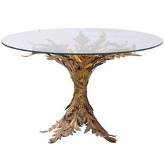 a round glass table with wooden branches on the top and bottom, against a white background