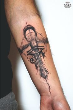 a man's arm with a cross and an arrow tattoo on the left forearm