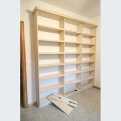 a large empty bookcase in the middle of a room