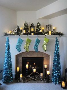 a fireplace decorated for christmas with stockings and candles