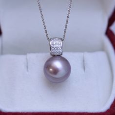 Dazzle in this stunning 11-12mm Freshwater Pearl Pendant Necklace. Handcrafted with 11-12mm freshwater pearls and blue gems, this necklace will be the perfect addition to any bridal ensemble. Boasting a remarkable luster and gleam, these pearls create a luxurious statement that will captivate the eye of any admirer. The deep purple hues of the pearls are perfectly complemented by sparkling blue gems for a truly timeless look. Elevate your style with this showstopper from House of Pearls. 11-12mm Wedding Pearl Necklace With Gemstone, Formal Bridal Necklace With Pearl Pendant, Adjustable Pearl Necklace, Formal Pearl Necklace With Gemstone, Silver Bridal Necklace With Pearl Charm, Baroque Pearls Necklace, White Gold Pendant Necklace, Mother Of Pearl Earrings, Baroque Pearl Earrings