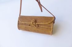 Wicker shoulder and clutch basket bag with leather strap and closure. Inside has a cotton fabric lining. The strap can be inserted inside and you can use as a clutch bag. Wicker bag is excellent choice to coordinate with Hawaiian dress. Condition: New 10.5" W x 5" Tall x 4.5" Wide