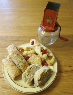 a plate full of food sitting on top of a wooden table next to a jar