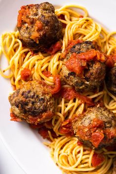 spaghetti with meatballs and tomato sauce on it