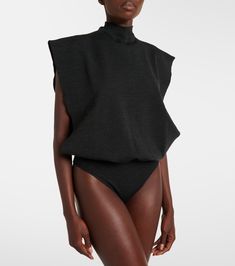 Wool bodysuit in black - Alaia | Mytheresa High Neck Bodysuit For Workwear In Fall, Chic Winter Bodysuit For Workwear, Fall Workwear Bodysuit With High Neck, Winter Workwear Turtleneck Bodysuit, Fall Workwear High Neck Bodysuit, Winter Turtleneck Bodysuit For Workwear, Elegant Turtleneck Bodysuit For Workwear, Modern Fitted Wool Tops, Fitted High Waist Tops For Workwear